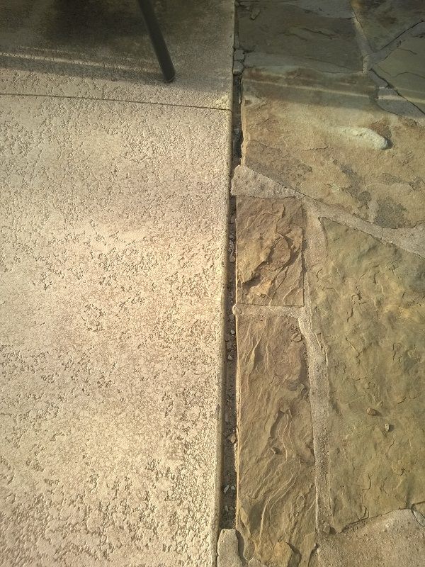 Flagstone mortar completely gone where it meets concrete